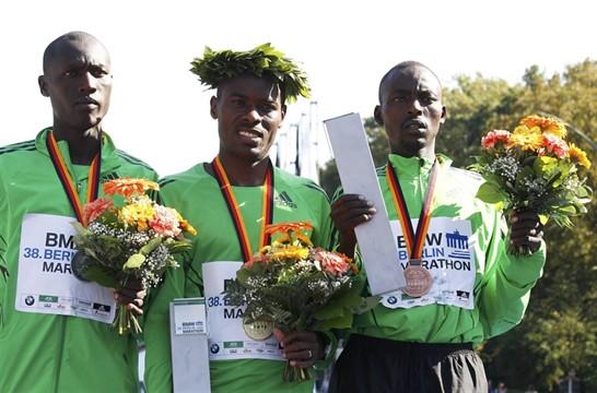 Stephen Chemlany (left) at the Berlin Marathon awards ceremony with world record holder Patrick Makau.
