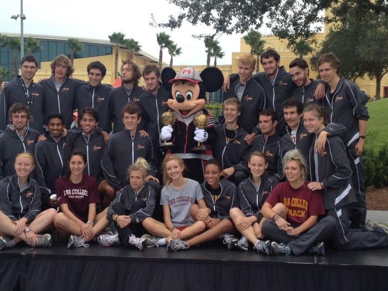 Men’s and women’s cross country squads take a picture with Mickey to celebrate the win.