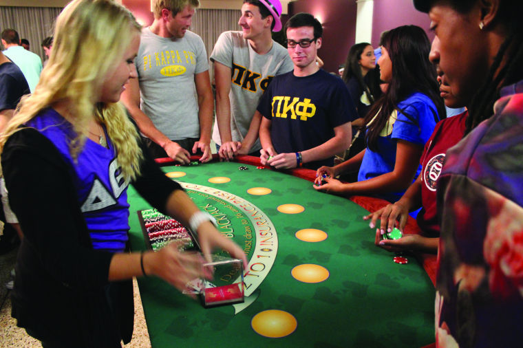 Students+enjoy+playing+21+at+the+Council+for+Greek+Governance%E2%80%99s+Casino+Night+on+Sept.+14.+Participants+played+casino-style+games+to+earn+chips%2C+which+they+could+trade+in+for+raffle+tickets+for+a+chance+to+win+prizes.