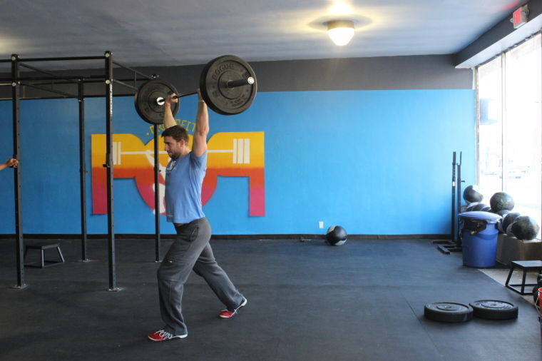 POP Co-Owner and Coach Nick Schoonmaker demonstrates a Crossfit technique at the North Avenue “box.”