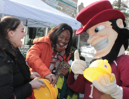 Killian the Gael passes out hard hats to students attending the diner demolition event on Friday, Jan.30.