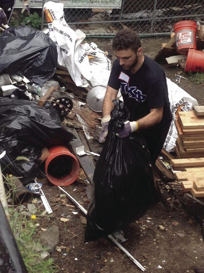 An Iona student clears out a property in Yonkers for Habitat for Humanity