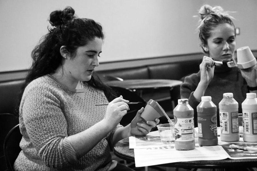 Students painted terra-cotta pots with colorful paint and learned sign language at Pottery Night in the Endzone. 