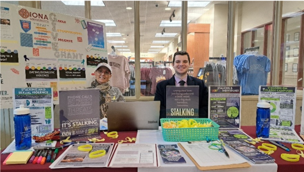 (Left to right) Iona University G.I.V.E. Grant Director Leonora Campbell and WestCOP Central Violence Prevention Educator Kevin Landino hosting a stalking information table at LaPenta Student Union. 