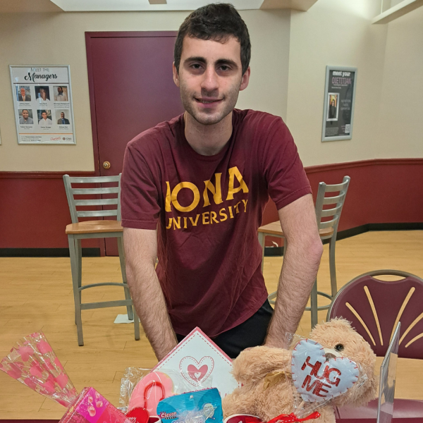 Neurodivergent Club President Ethan Moskowitz 24 helps run the #LOVELIKETHAT info table, raising awareness about dating violence. 